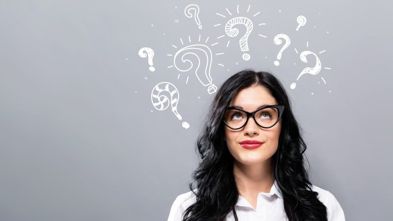 Woman with question marks above her head as if thinking