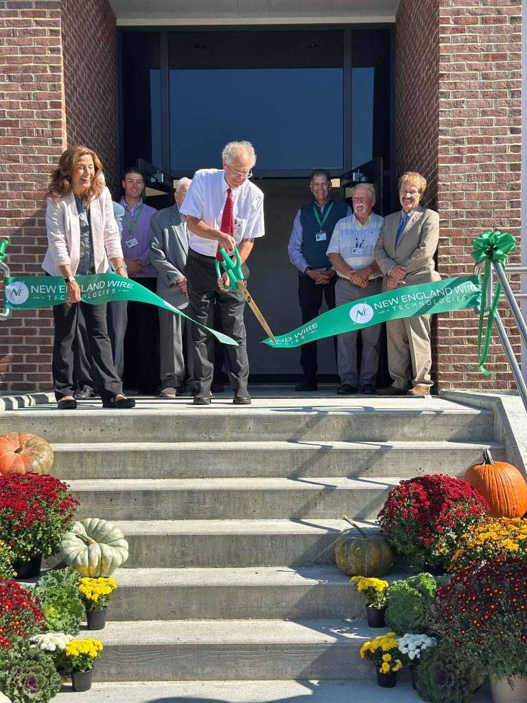 Tom White cuts the ribbon at the grand opening of the new 2025 addition at new England Wire Technologies
